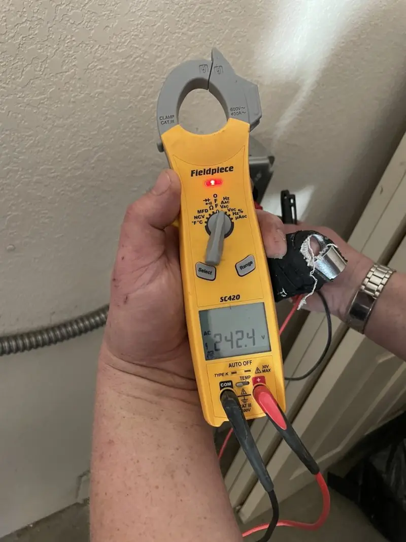 Voltage testing with clamp meter during Ceiling Fan Installation in Prichard